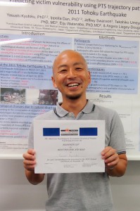 Dr. Yasushi Kyutoku holding the Best Poster Award Certificate